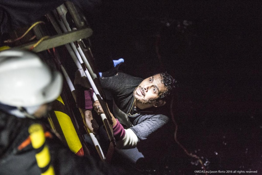 11.45pm the MOAS team make a sighting of a large rubber dinghy with 48 people onboard ( 8 males, 16 females and 14 children). The boat is in distress in the heavy swell. Three men are then spotted in sea by the MOAS searchlight. The men looking exhausted are encouraged to swim and grasp hold of the Jacobs ladder hanging on the side of the MOAS Rescue ship, Responder. With rescues swimers at the ready, the men are pulled to safety. The men had fallen from the dinghy and could not climb back due to the high seas and their boat being already so overcrowded. Their rubberboat with their familiy members aboard was then safely brought alongside the Responder and all remaining 45 people, mainly Syrians were brought on deck, exhausted and wet.